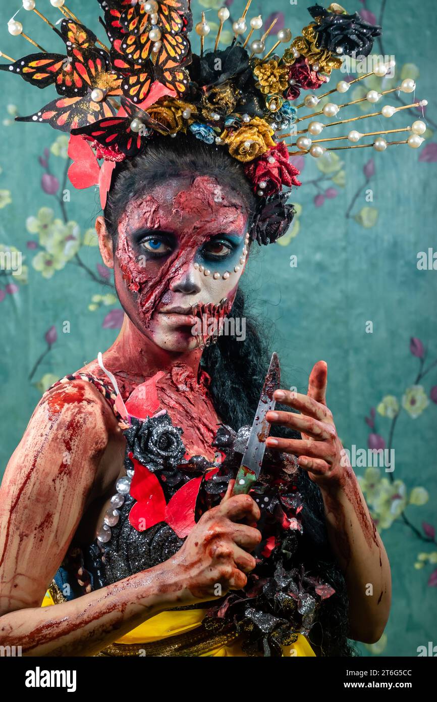 Closeup face of woman dressed in costume for Halloween Night.atmosphere covered by thin smoke.Creative, artistic, Halloween concept. Stock Photo