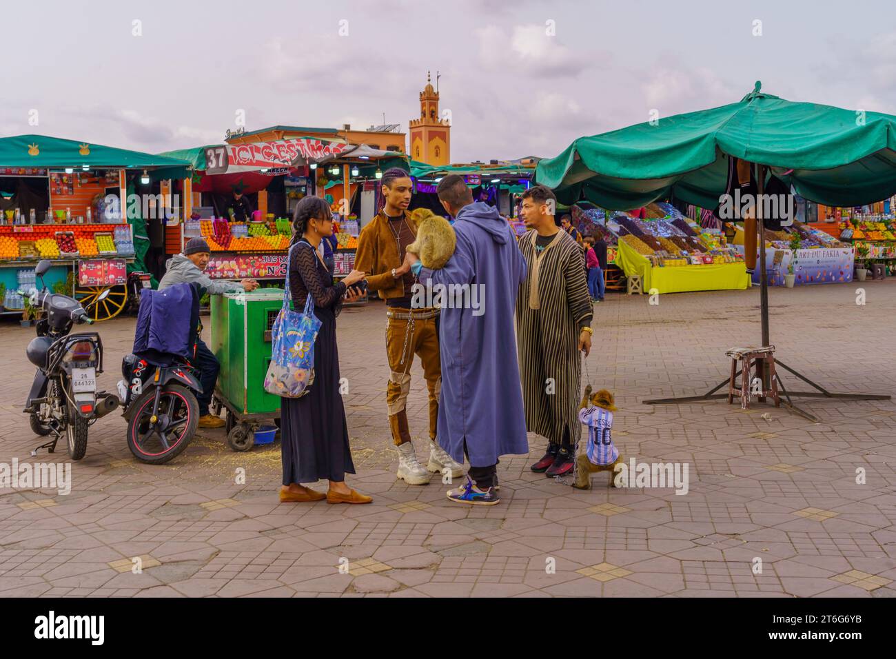 Trainer with monkey on a chain in Place Djemaa el Fna square marketplace in  Marrakech Morocco Stock Photo - Alamy