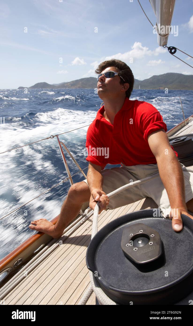 Sailor trims the sails onboard a racing sloop Stock Photo - Alamy