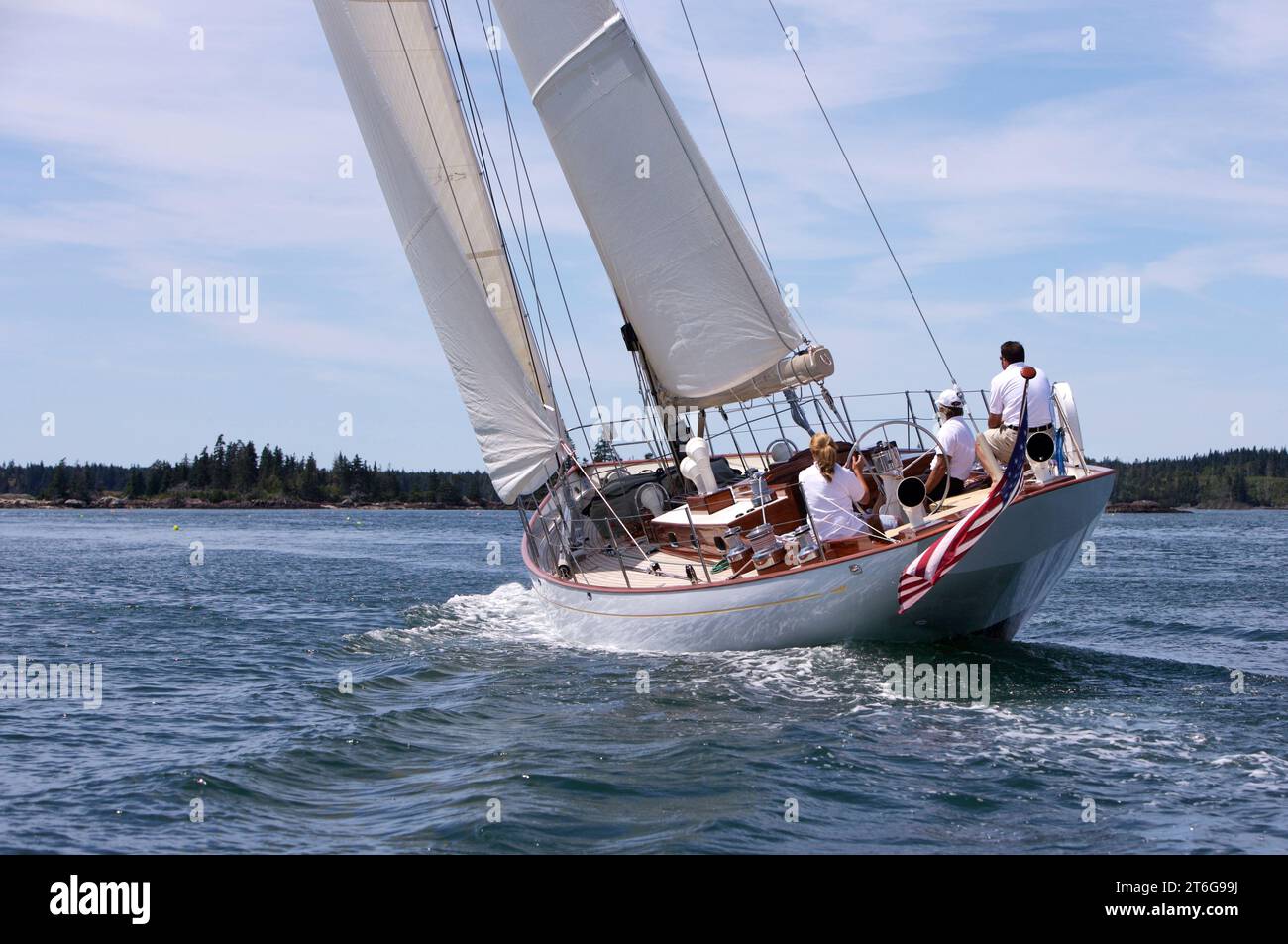 A classic wooden yacht sails through the Fox Island Thoroughfare off the coast of Maine. Stock Photo