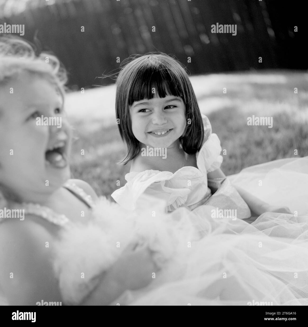 Two girls, best friends play in their princess dresses. Stock Photo