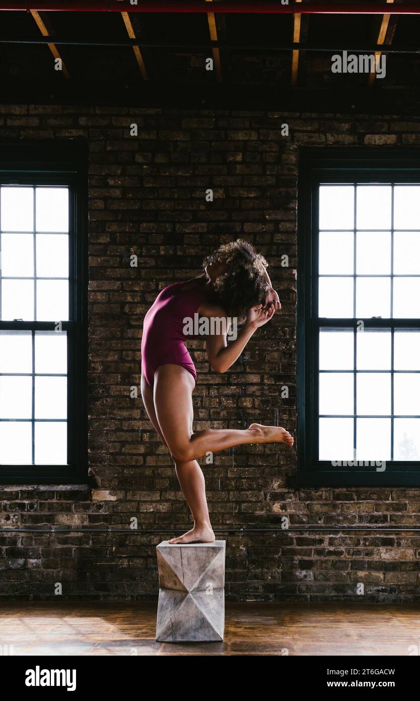 Woman dancer poses with legs and arms in body figure Stock Photo