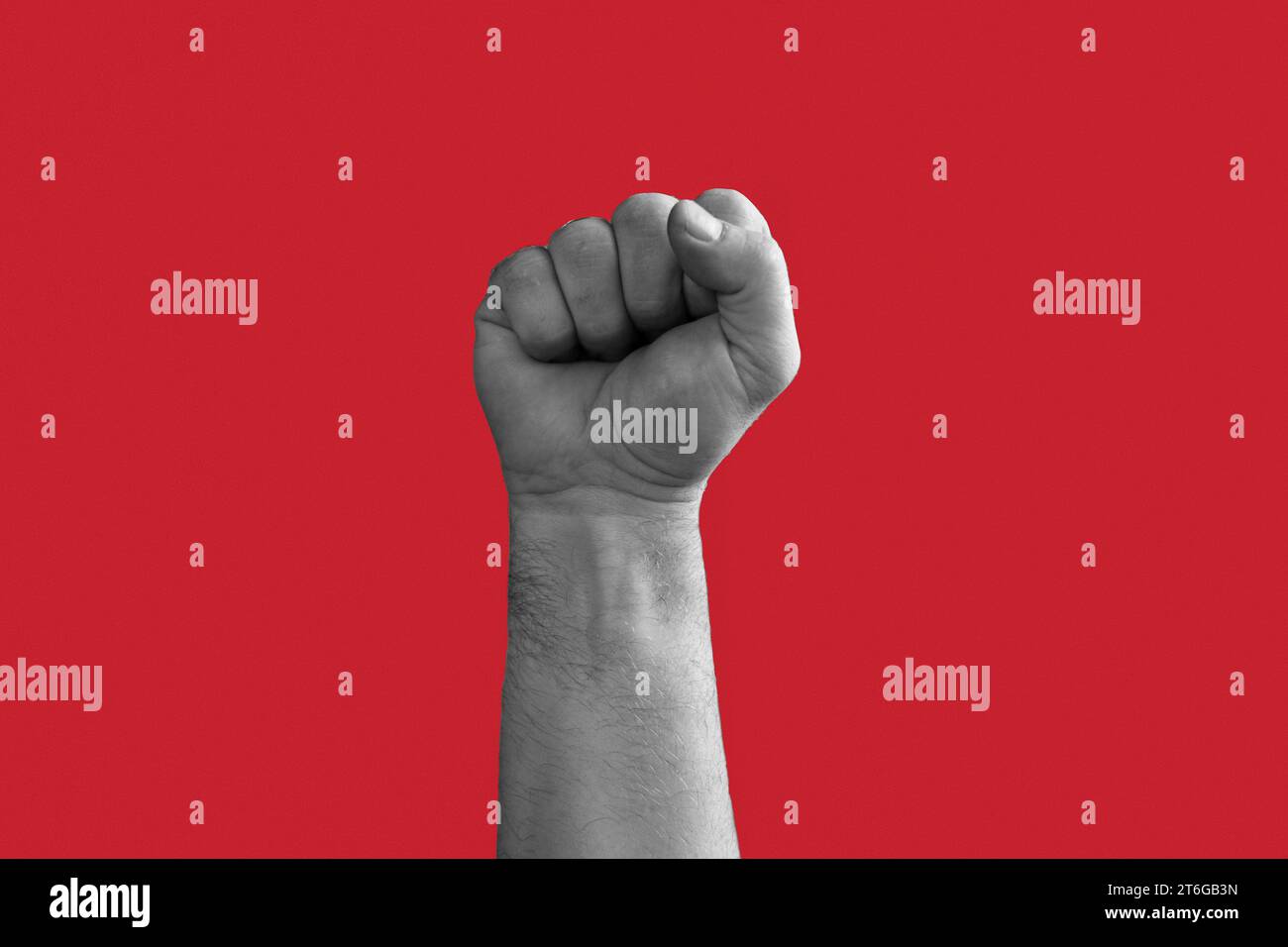 Black and White Man Hand with Raised Fist isolated on Red Background