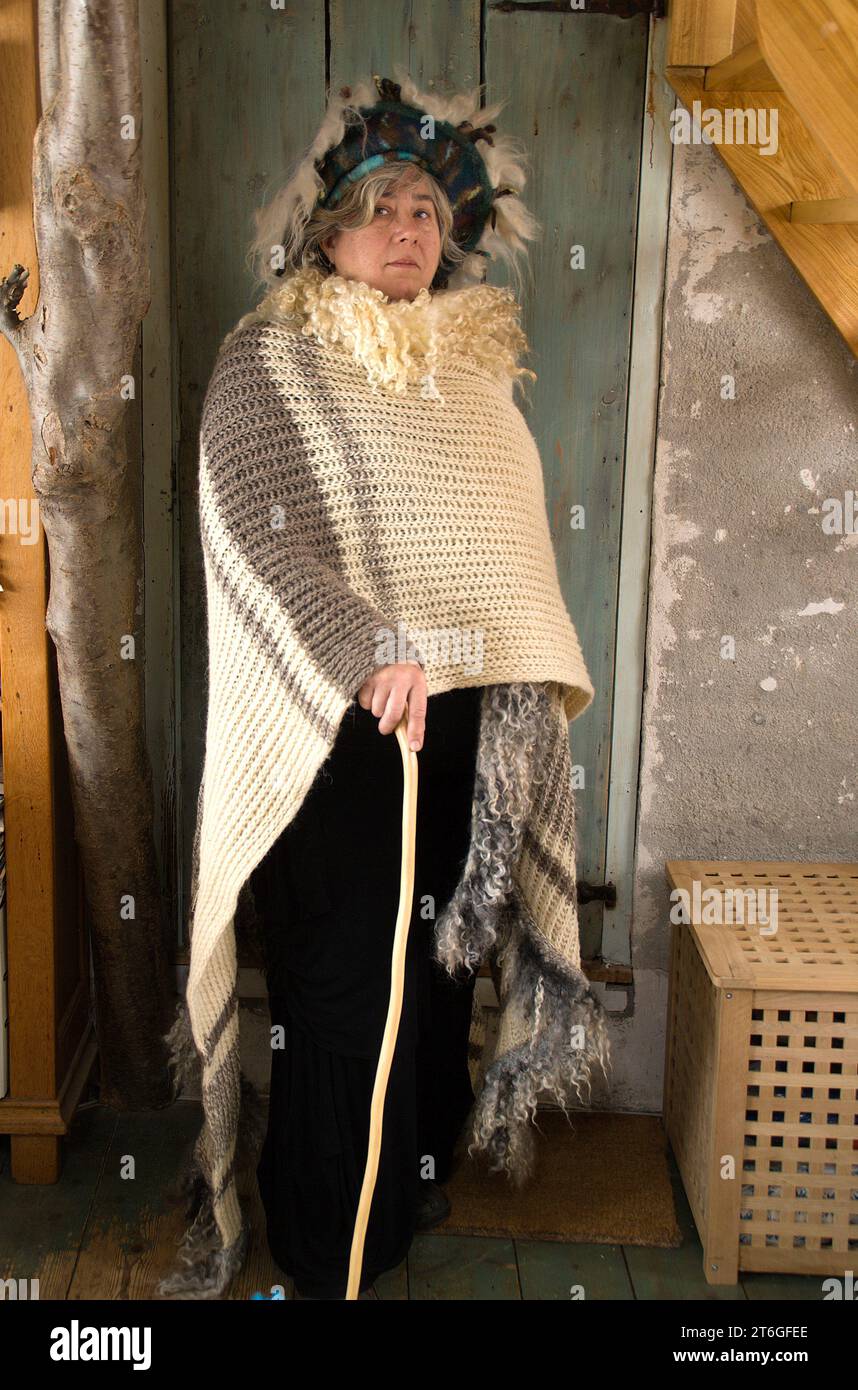 Erna Alexandra Jansen, creative therapist and shamanka, poses in a self-made shawl, with an exuberant headdress on her head. Stock Photo