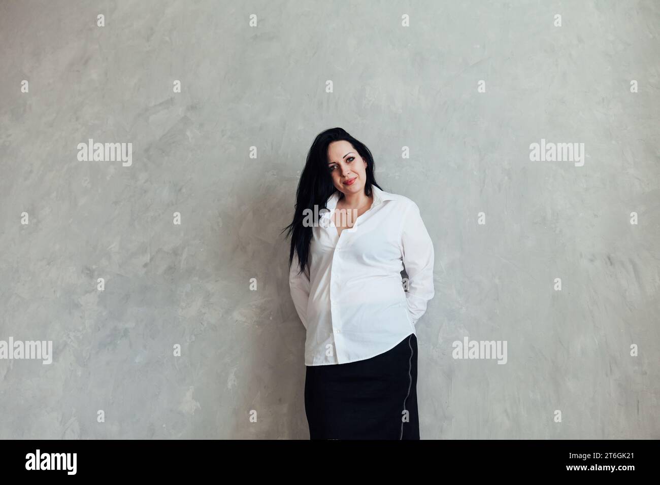 Portrait of a brunette woman in a white business suit Stock Photo - Alamy