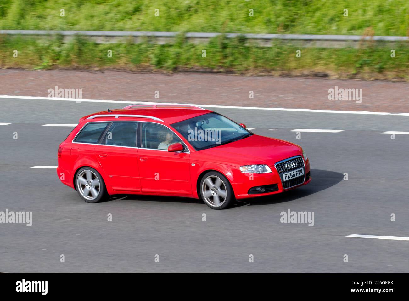 2006 Audi A4 Avant S Line Tdi 140 Tdi TDV 140 Red Car Estate Diesel 1986 cc; travelling at speed on the M6 motorway in Greater Manchester, UK Stock Photo