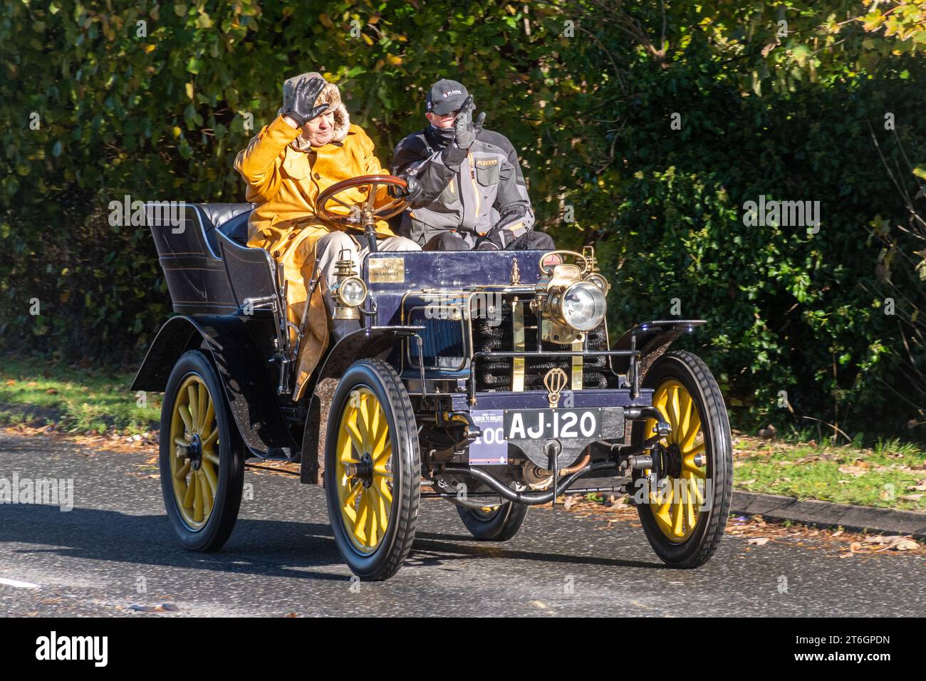 A yellow 1901 Decauville Donneau car in the London to Brighton veteran car run event on 5th November 2023, West Sussex, England, UK Stock Photo