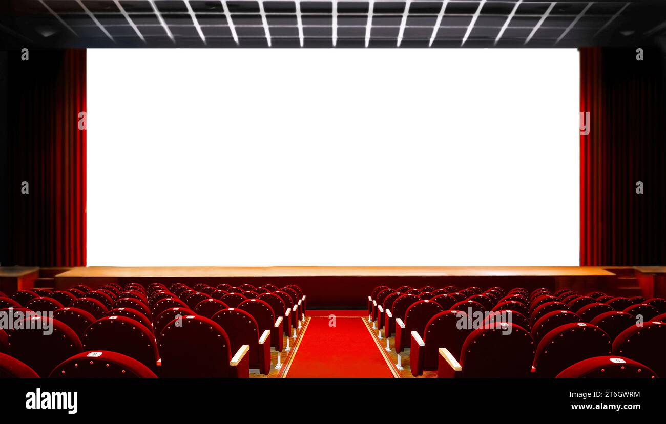 Empty red cinema seats with blank white screen Stock Photo
