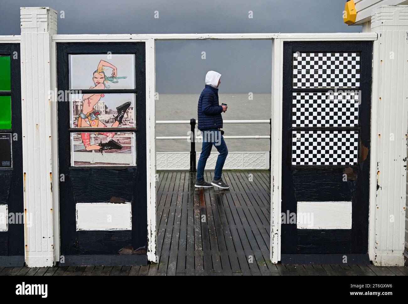 Worthing UK 10th November 2023 A visitor on Worthing Pier in the wind