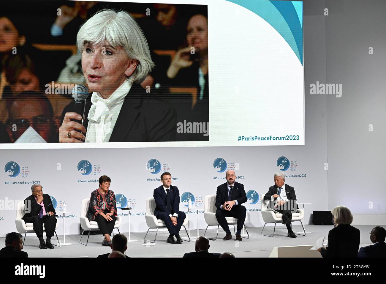 NK Singh, Ristalina Georgieva (IMF), President Emmanuel Macron, President of the European Council Charles Michel and Jin Liqun (AIIB) Laurence Tubiana on screen attending the 6th edition of the Paris Peace Forum at the Palais Brongniart in Paris, France on November 10, 2023. Representatives from states, international organisations, businesses, development banks or NGOs are expected to attend the event, held from November 10 to 11, 2023. This year's themes are protection of the planet and people, trust and safety in the digital world, sustainable development, crafting peace and building a safer Stock Photo