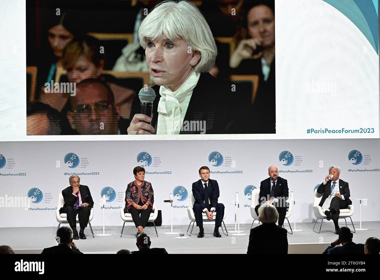 NK Singh, Ristalina Georgieva (IMF), President Emmanuel Macron, President of the European Council Charles Michel and Jin Liqun (AIIB) Laurence Tubiana on screen attending the 6th edition of the Paris Peace Forum at the Palais Brongniart in Paris, France on November 10, 2023. Representatives from states, international organisations, businesses, development banks or NGOs are expected to attend the event, held from November 10 to 11, 2023. This year's themes are protection of the planet and people, trust and safety in the digital world, sustainable development, crafting peace and building a safer Stock Photo
