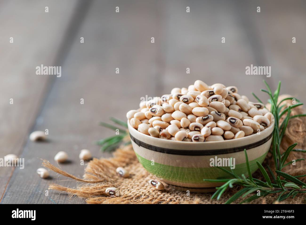 navy bean or white kidneys beans on wood background. White beans are the most abundant plant-based source of phosphatidylserine and lower cholesterol Stock Photo