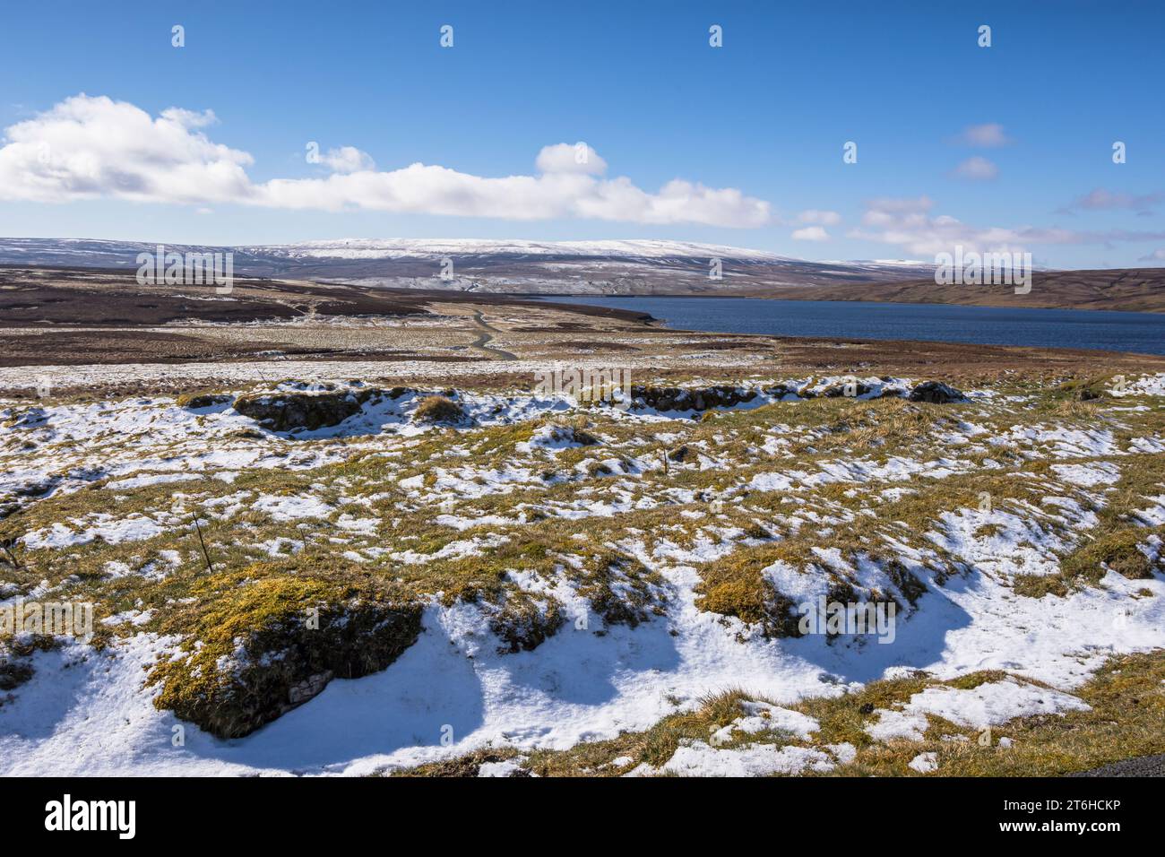 Man made Cow Green resevoir, alpine landscape with spring snow that is home to many rare upland plant species & breeding waders, Upper Teesdale, Co Du Stock Photo