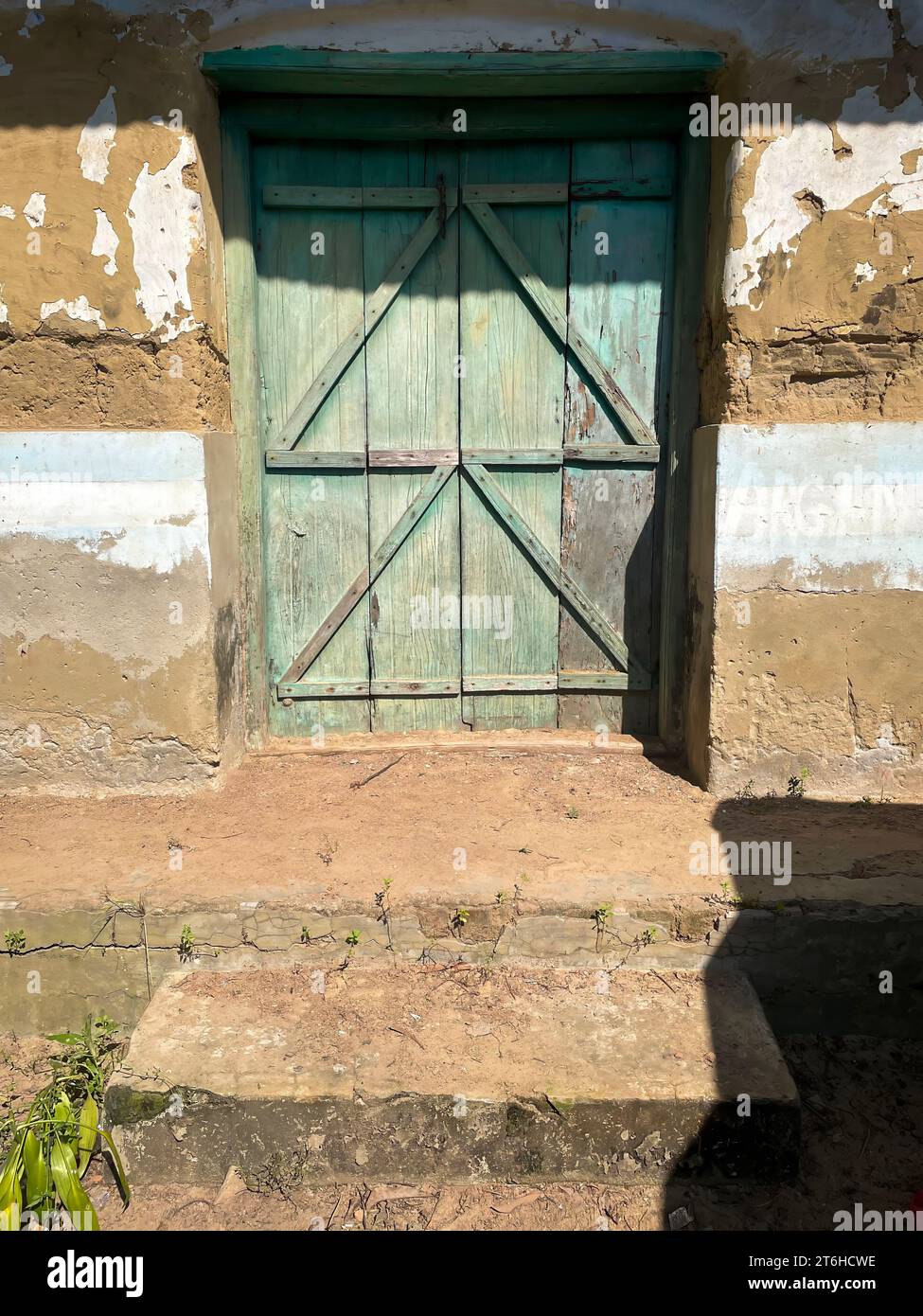Old blue door on a village mud house in Bangladesh. Stock Photo