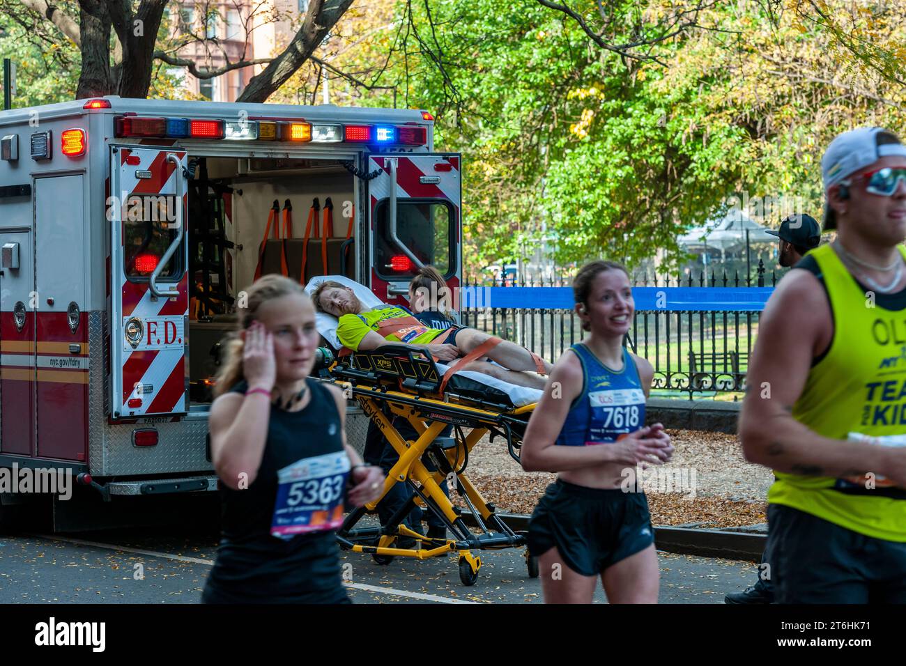 EMT’s load a runner into their ambulance as runners pass through Harlem ...