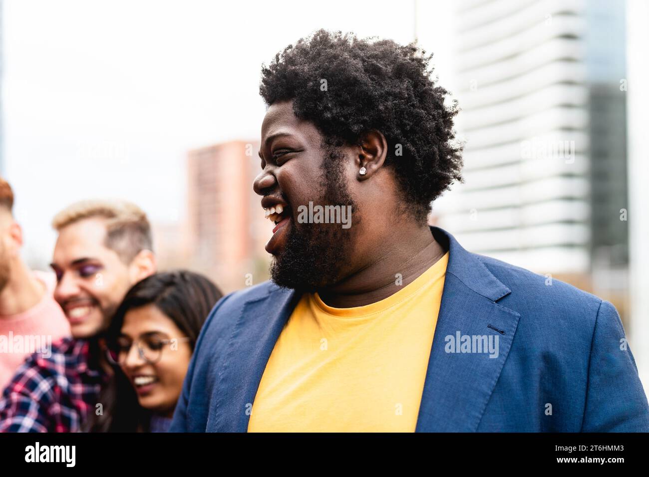 Young multi ethnic friends having fun together hanging out in the city - Friendship and diversity concept Stock Photo
