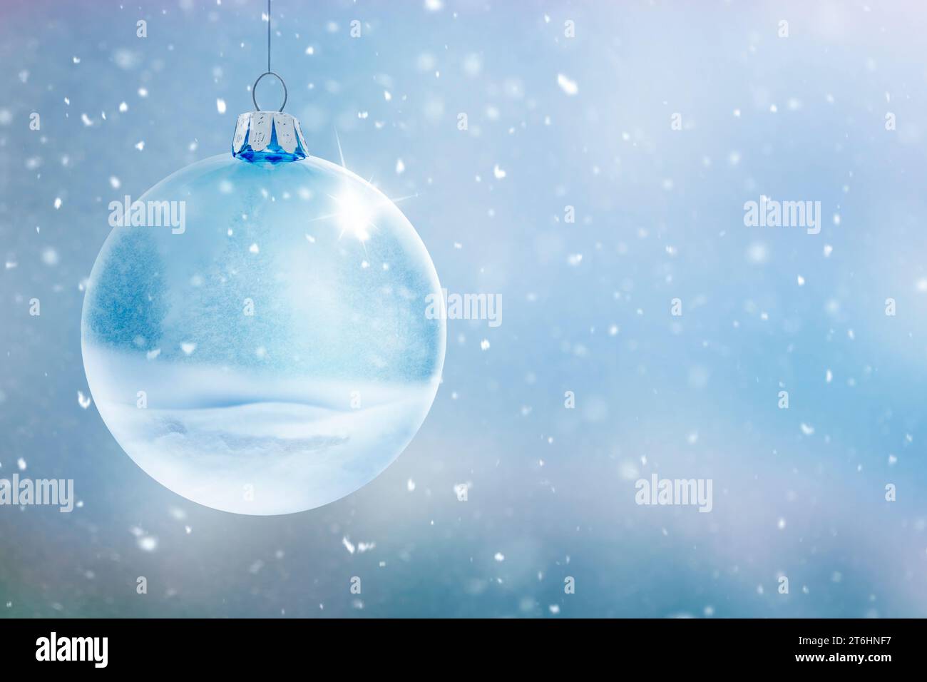 Transparent glass ball against blurred winter background with snowflakes Stock Photo