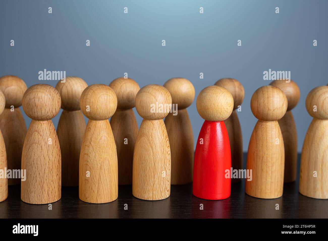 A red highlighted person in a crowd. Chosen candidate. The perpetrator is among the suspects. Zero patient, monitoring the epidemiological situation. Stock Photo
