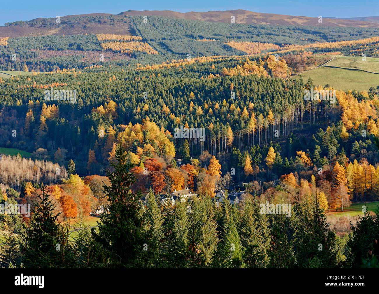 Balmoral Estates Crathie Scotland autumn sunshine over estate houses and hills all surrounded by colourful autumnal trees Stock Photo