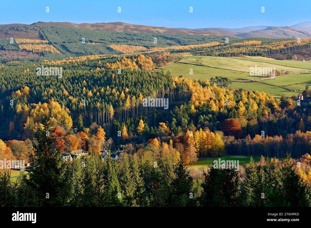 Balmoral Estates Crathie Scotland autumn sunshine over estate houses the hills and fields all surrounded by colourful autumnal trees Stock Photo