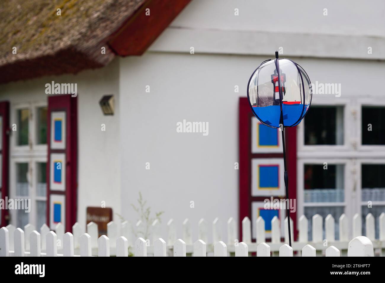 Detail of a typical thatched house on the Darß with colorful shutters Stock Photo