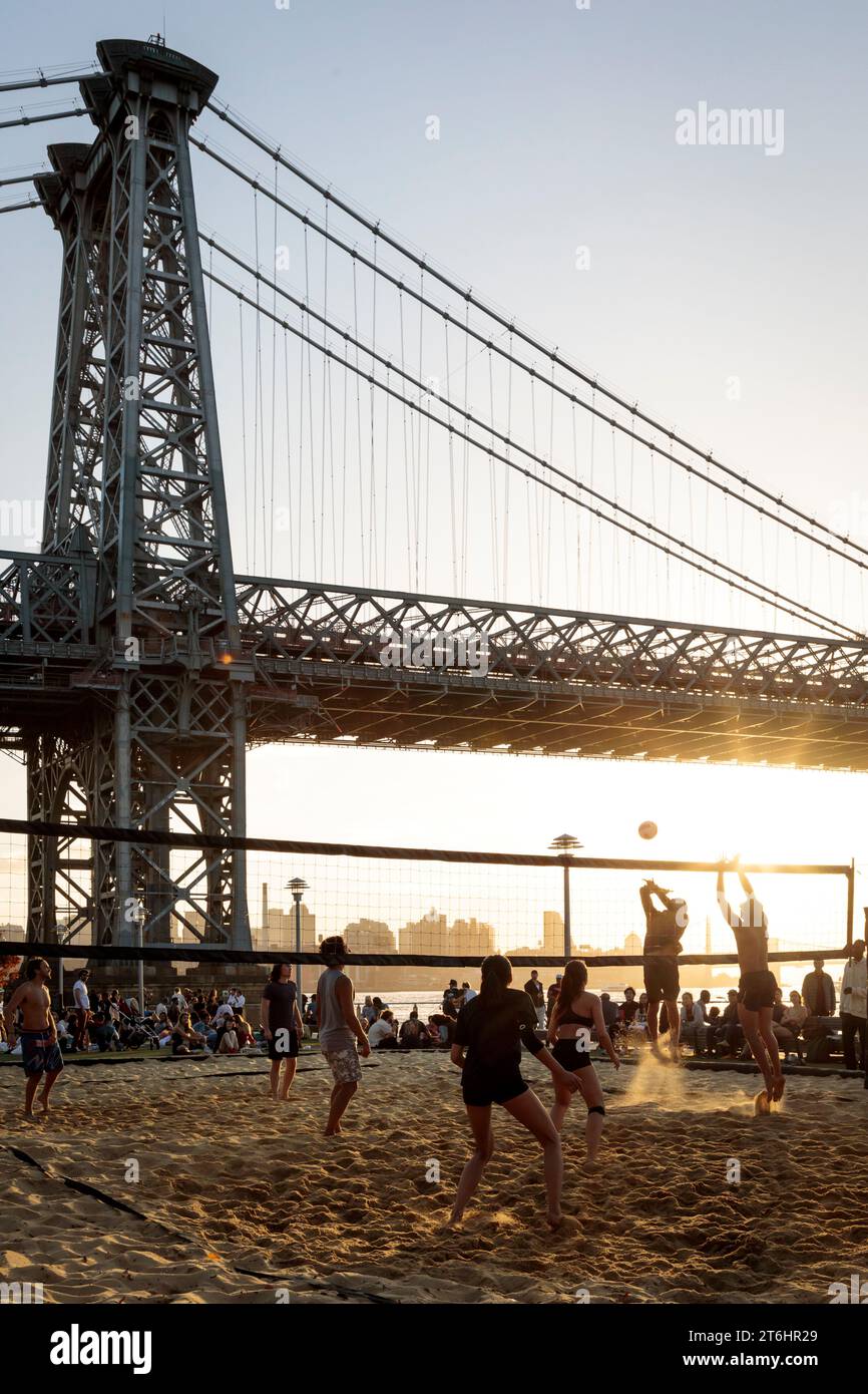 Sunset volleyball match in front of Williamsburg Bridge, New York City