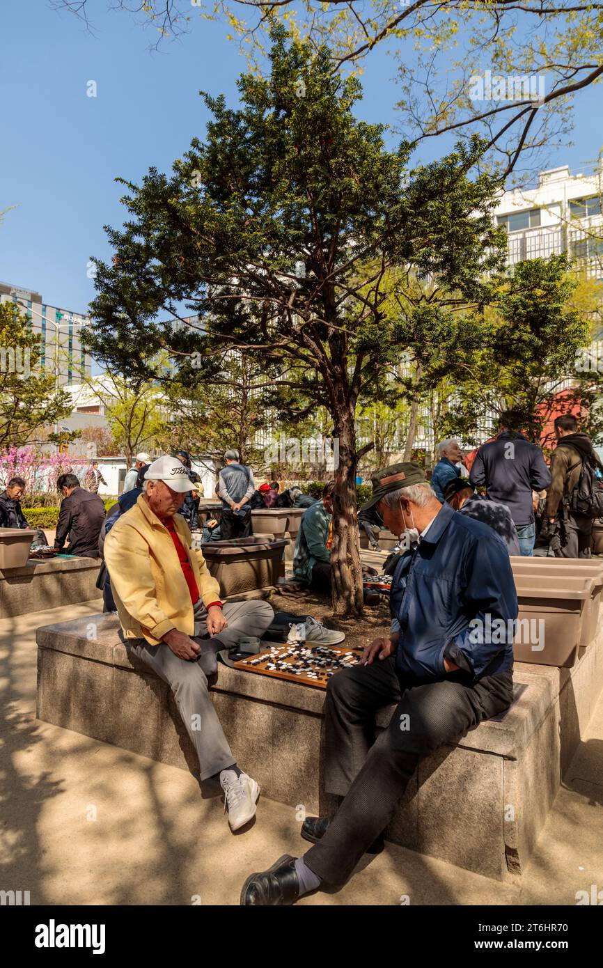 Older gentlemen playing Go in park, board game, South Korea Stock Photo