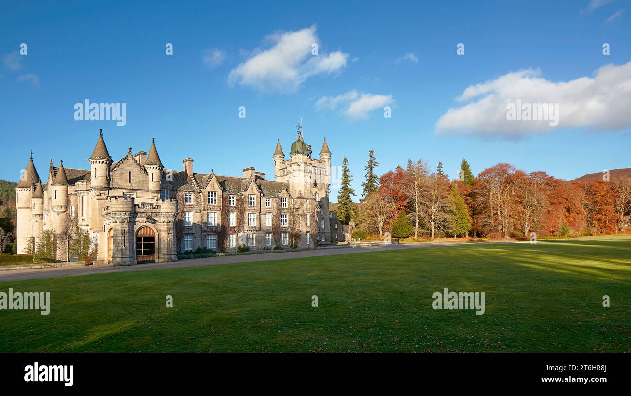 Balmoral Estates Crathie Scotland autumnal sunshine a blue sky over the castle and and lawns surrounded by colourful trees Stock Photo
