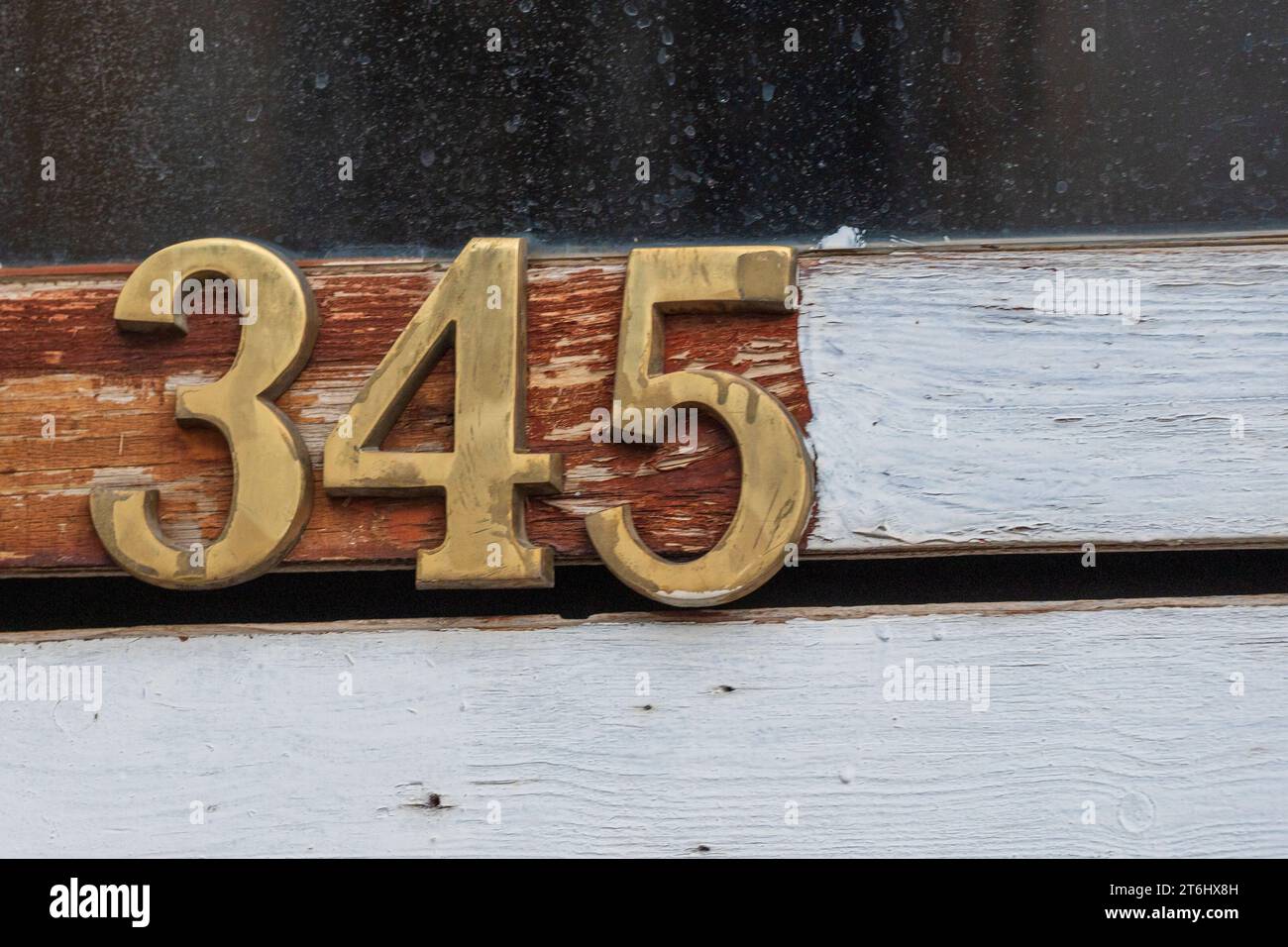 Numbers. Golden color. Detail. Old house glass door frame. 345. Learn to count, concept. Mathematical symbols. Odd and even number. Stock Photo