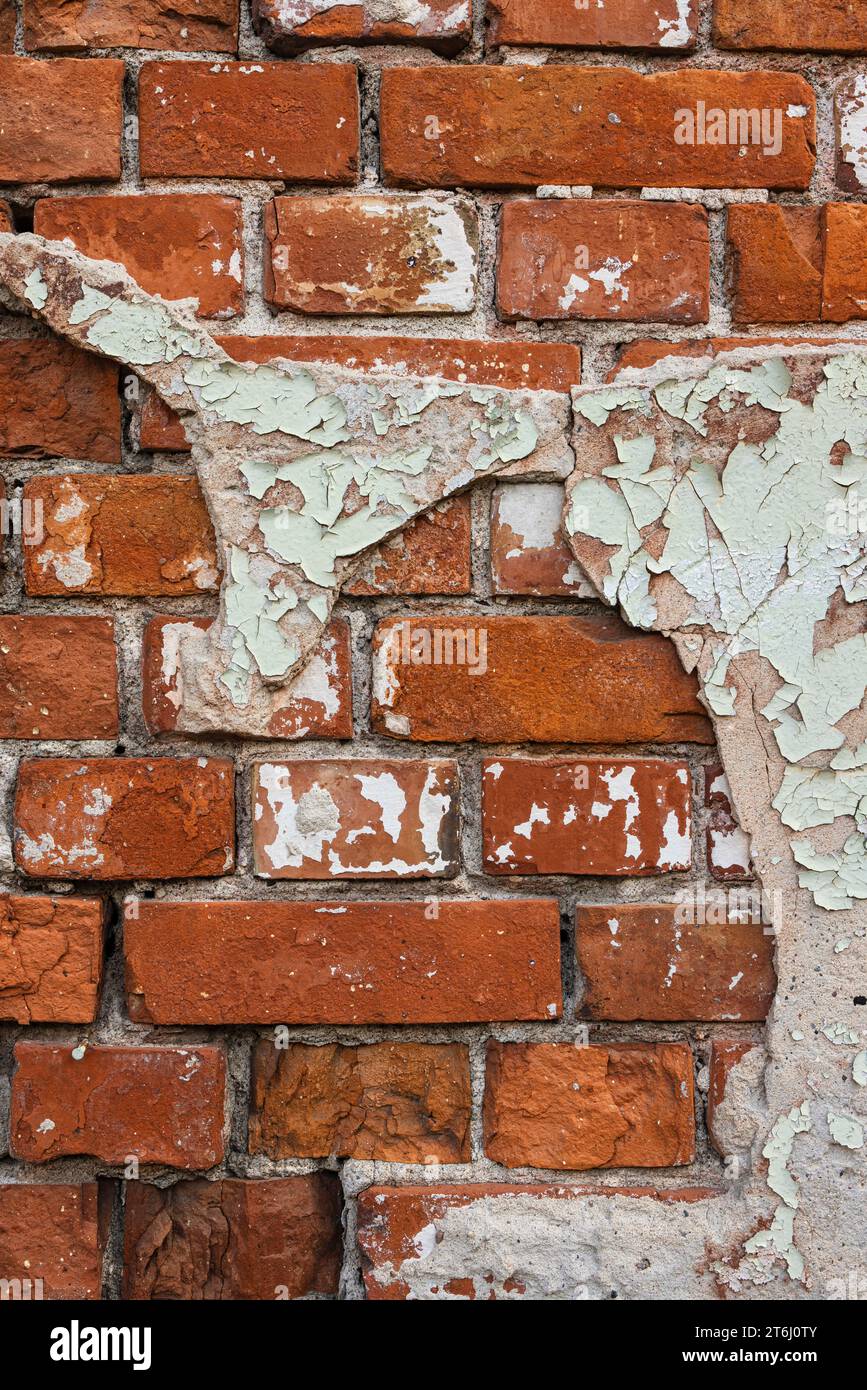 Facade of brick with crumbled plaster Stock Photo