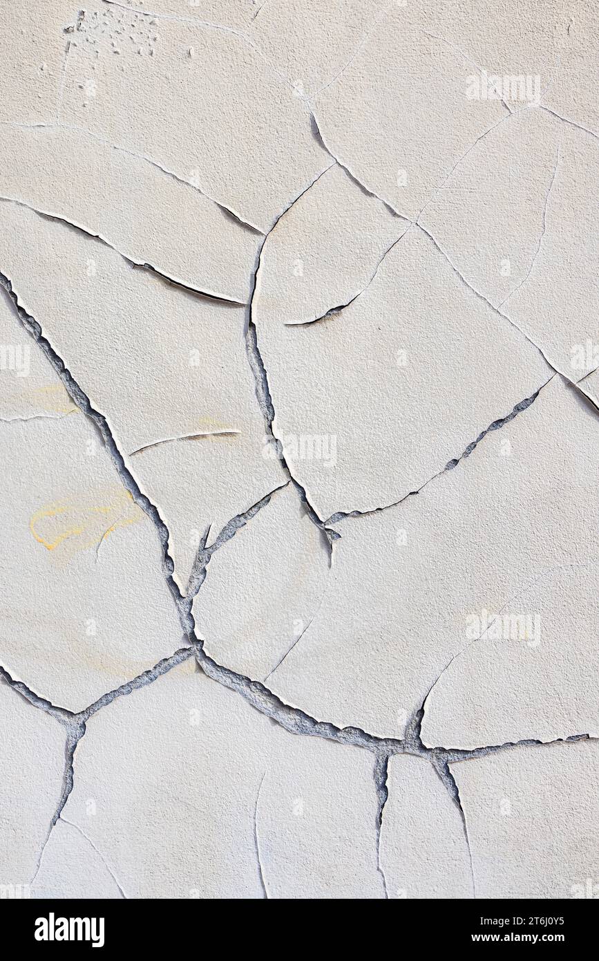 Wall, cracks in plaster, peeling old paint, wallpaper Stock Photo