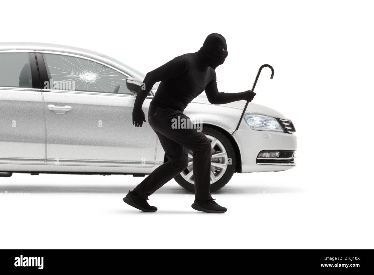 Burglar with balaclava and a crowbar breaking a car window isolated on