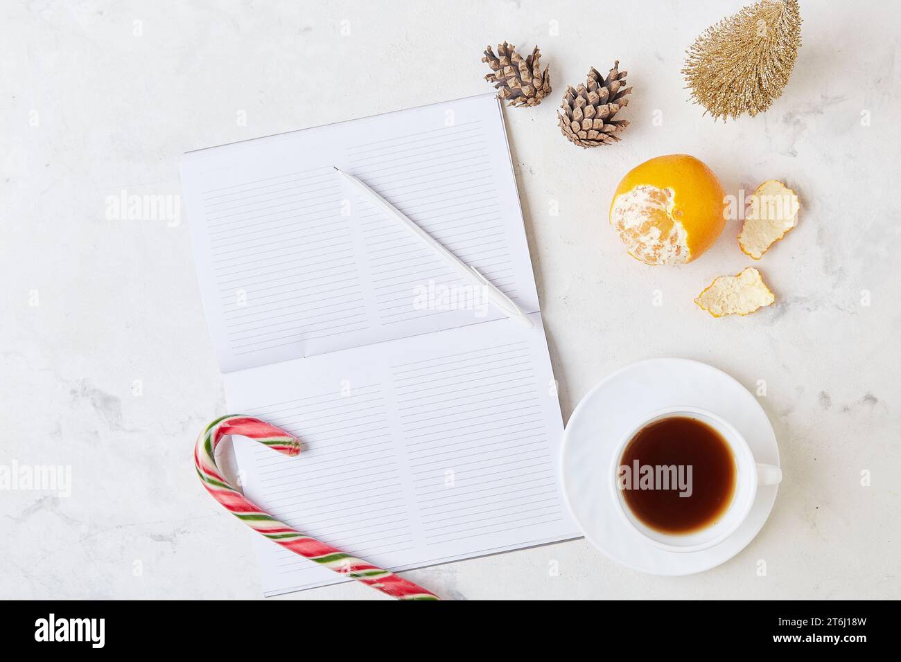 template scene with coffee cup, caramel stick and New Year's resolutions, setting the tone for fresh beginnings. Stock Photo