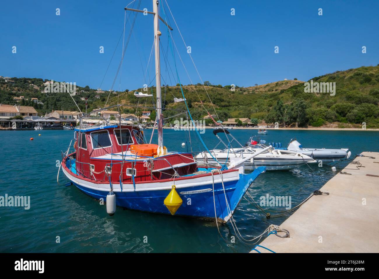 Agios Stefanos Avliotes, Corfu, Greece, fishing boats in the harbor of Agios Stefanos. Agios Stefanos was originally a fishing village for the nearby village of Avliotes on the northwest coast of the island of Corfu. Stock Photo