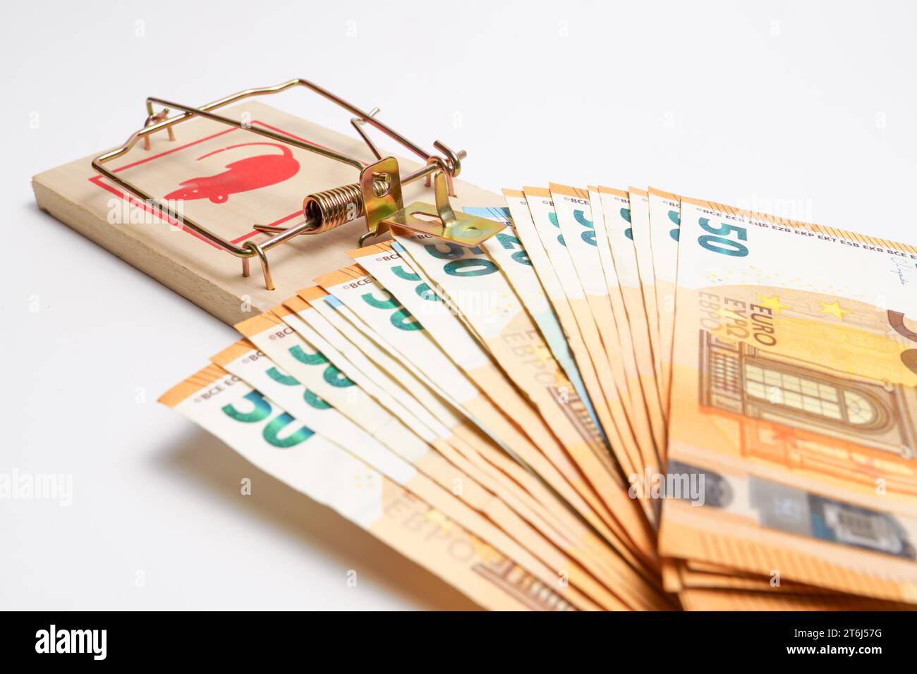 Euro banknotes in a mousetrap isolated on a white background, concept trapped by debts Stock Photo