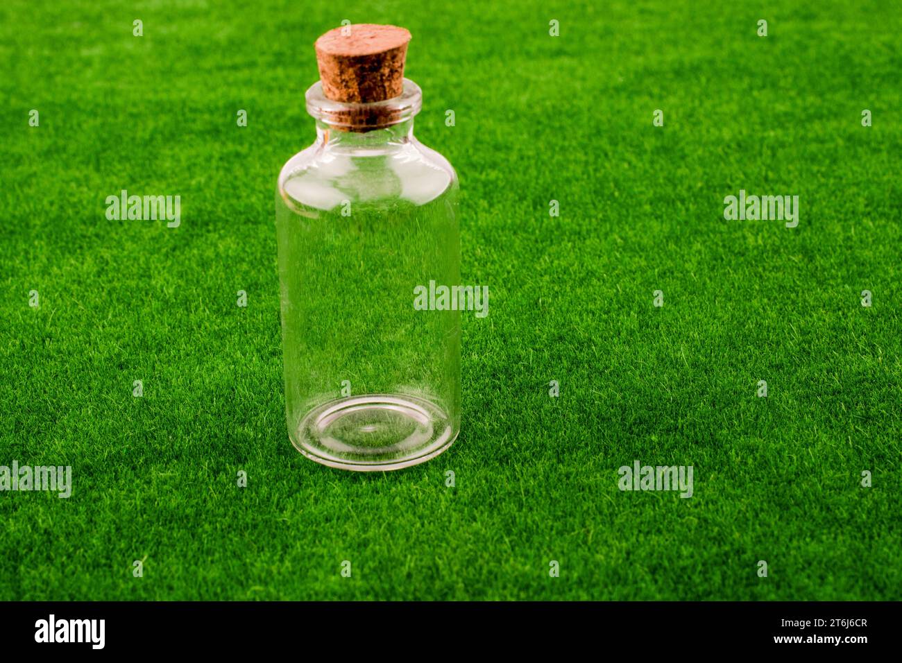 Littlegift box with a ribbon placed on green grass Stock Photo