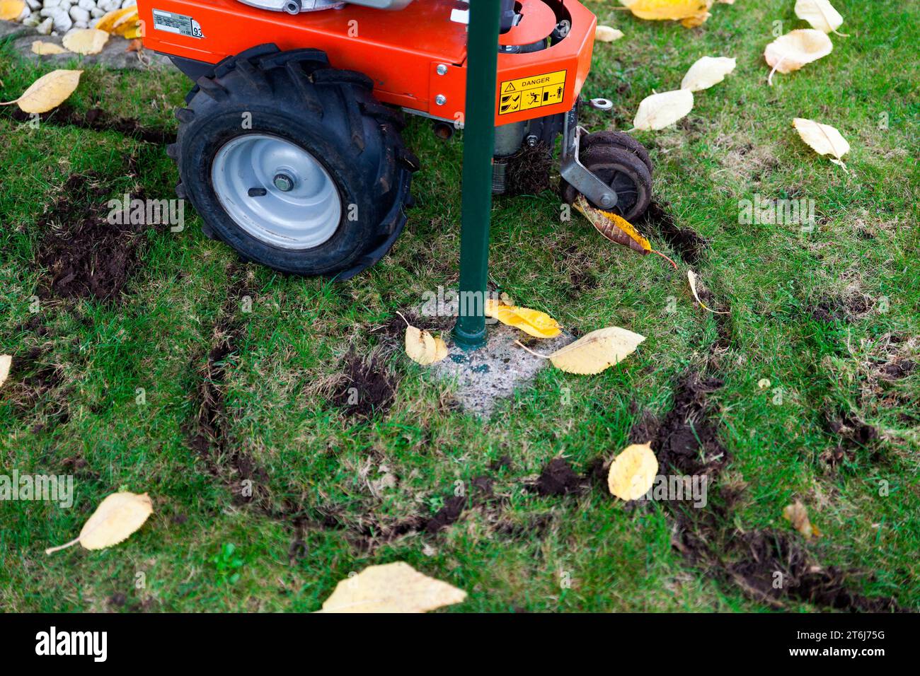 Installing a boundary wire for a robotic lawnmower Stock Photo Alamy