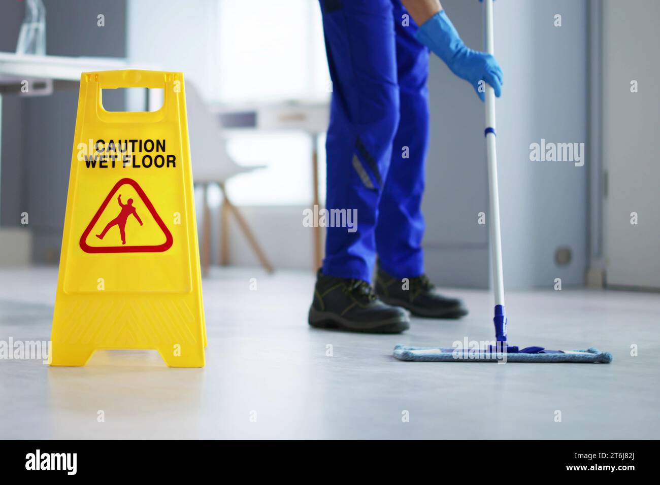 Caution Wet Floor Cleaning Janitor with Sign Stock Photo Alamy