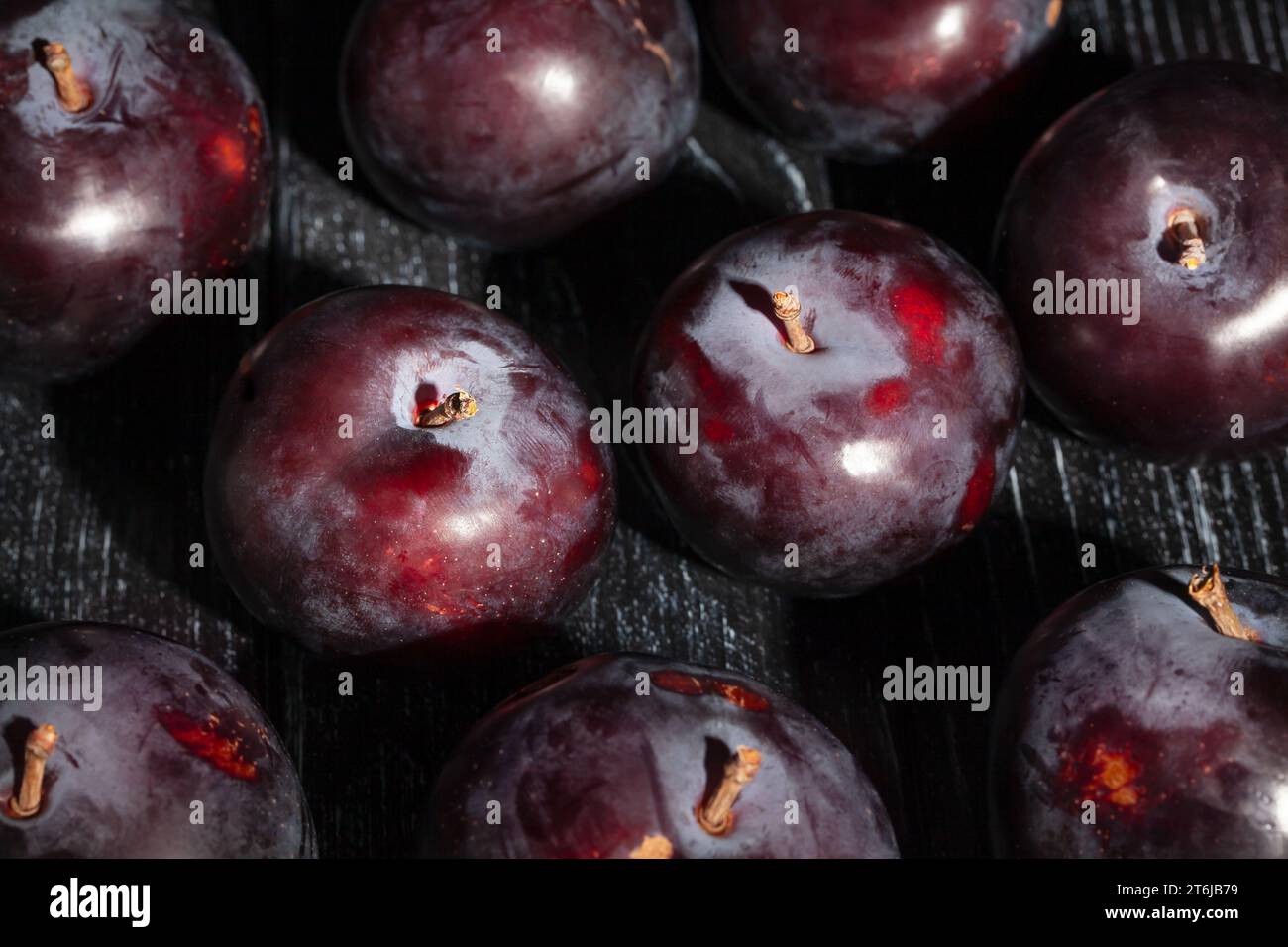 red plum on wood background Stock Photo