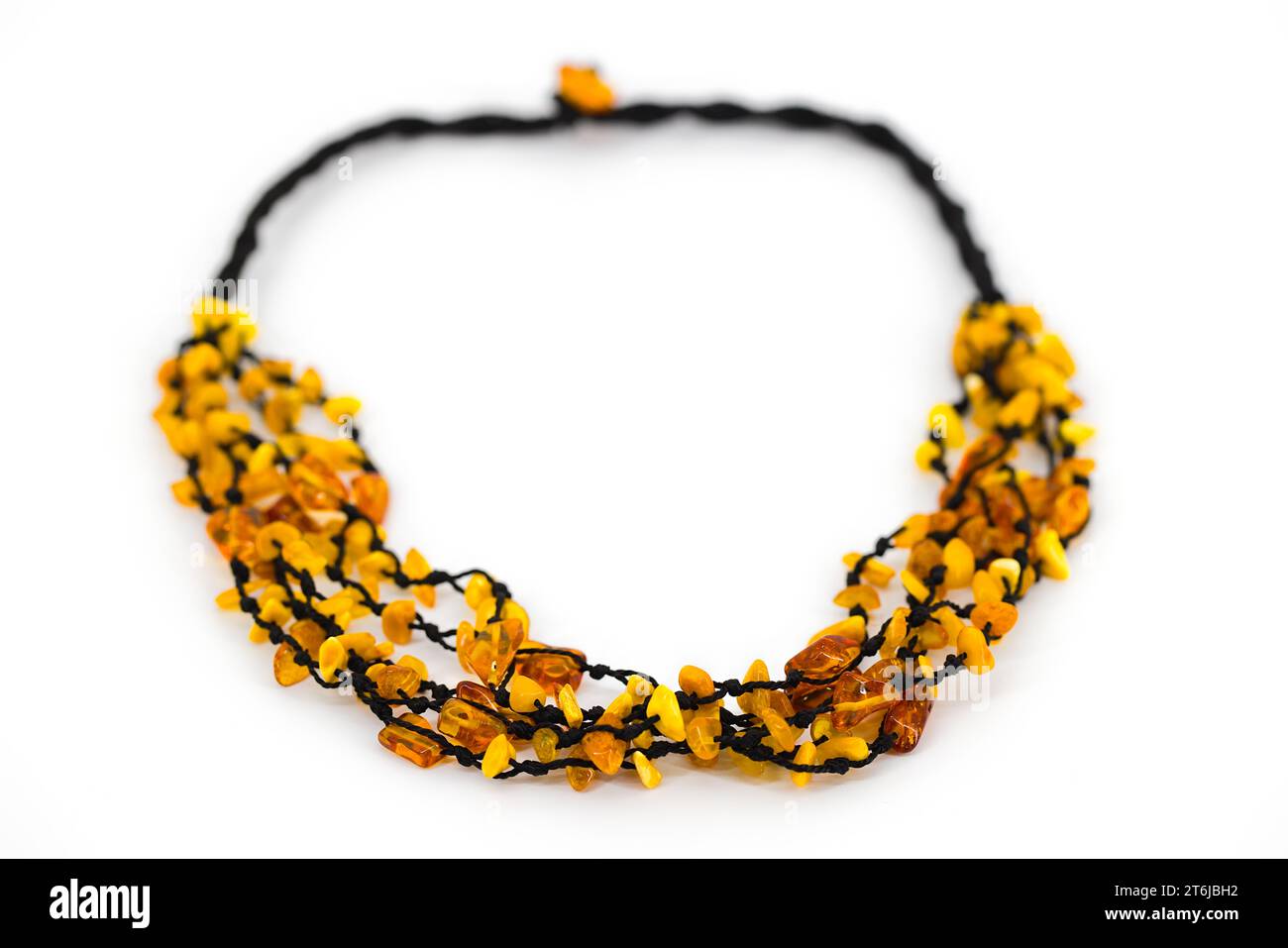 A polished amber necklace elegantly threaded on a black cord. The