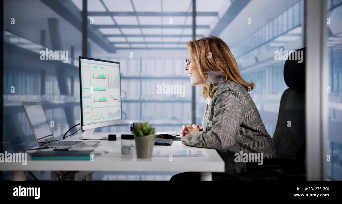 Excited Business Analyst Using Computer for Financial Data Stock Photo