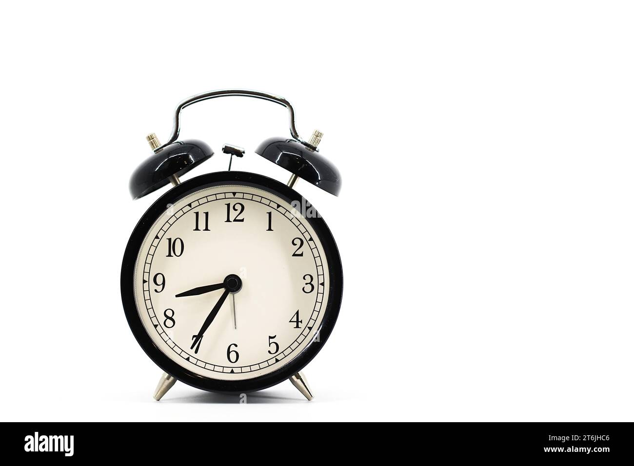 A black alarm clock featuring two bells on top, chrome handle, and legs