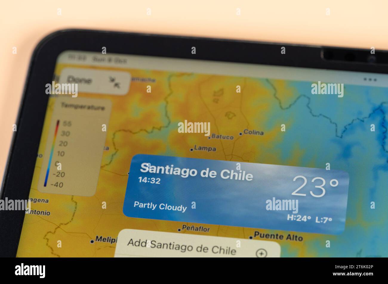 New York, USA - October 8, 2023: Checking temperature outside in Santiago city on online app ipad tablet screen close up view Stock Photo