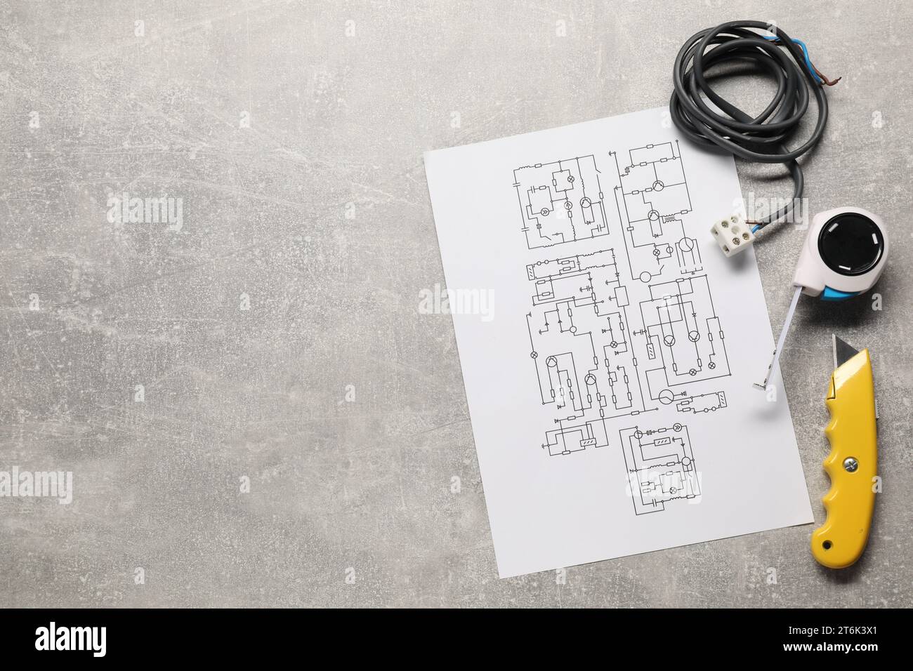 Wiring diagram, wires and tools on grey table, flat lay. Space for text Stock Photo