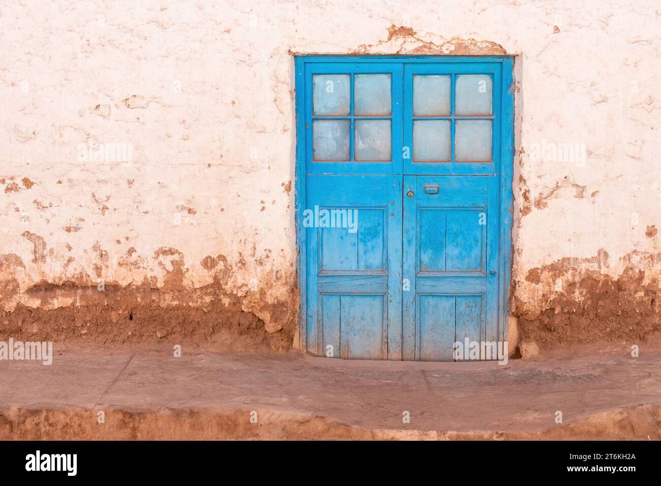 Blue double door with square windows in a building in San Pedro de Atacama, Chile. Stock Photo
