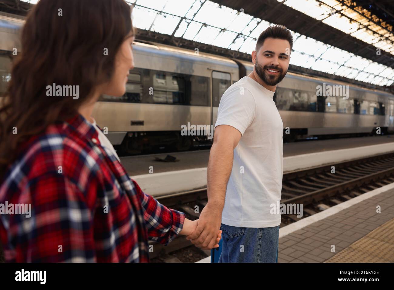 Longdistance relationship. Couple walking on platform of railway