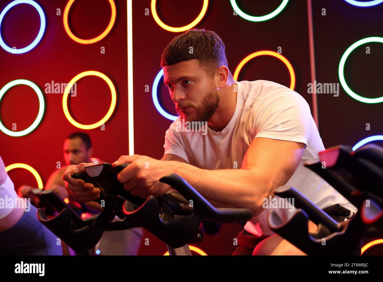 Group of people training on exercise bikes in fitness club Stock Photo ...