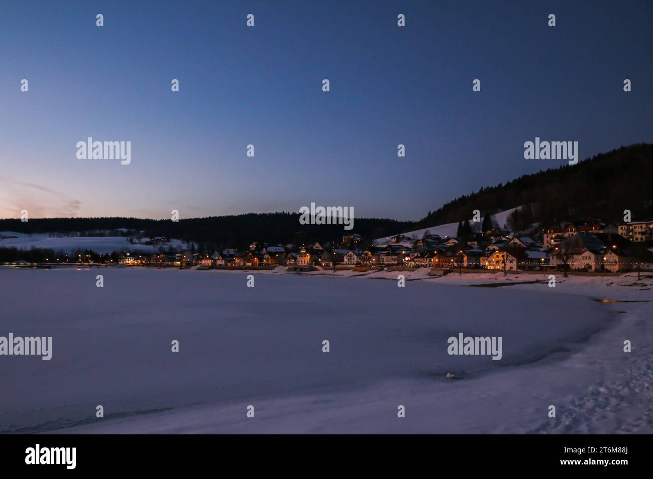Winter evening on the frozen lake of Joux. and the village Le Pont in vallée de Joux, swiss jura Stock Photo