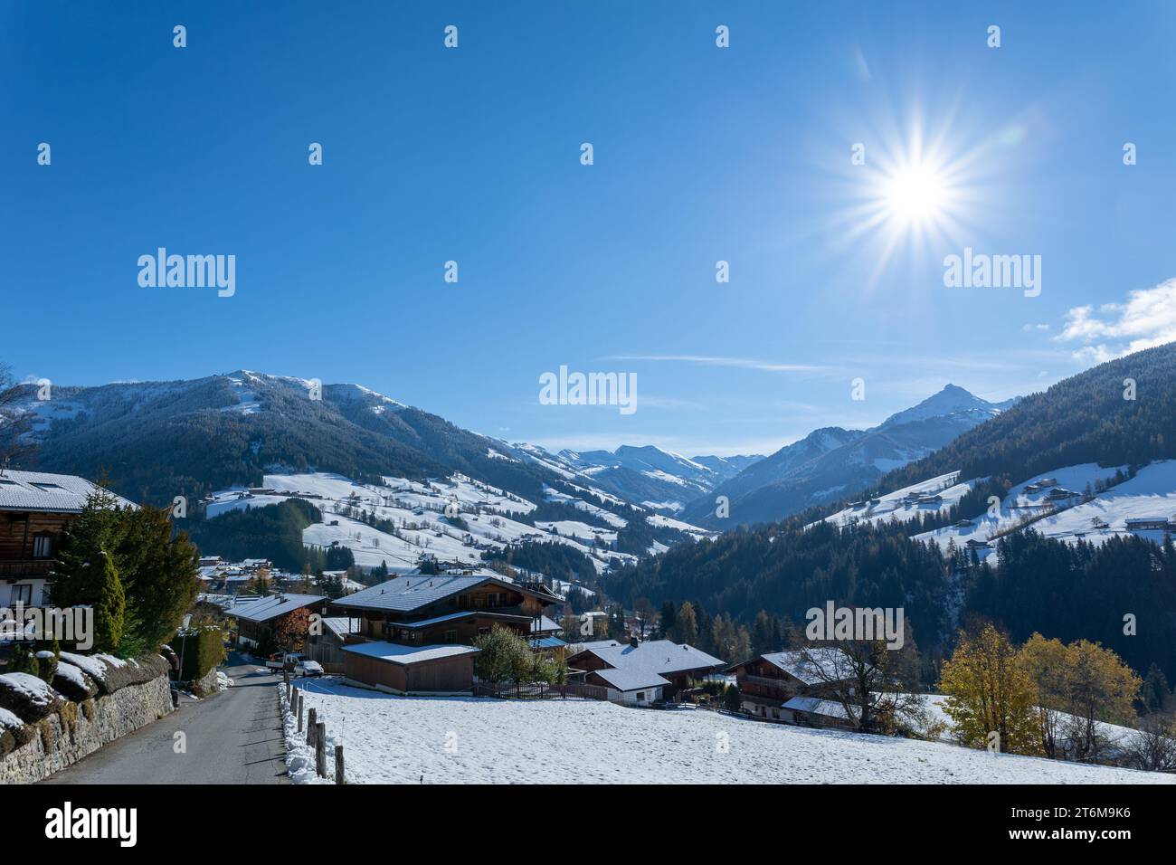 clear blue sky above alpbach village in austrian alps tyrol with snowy hills Stock Photo