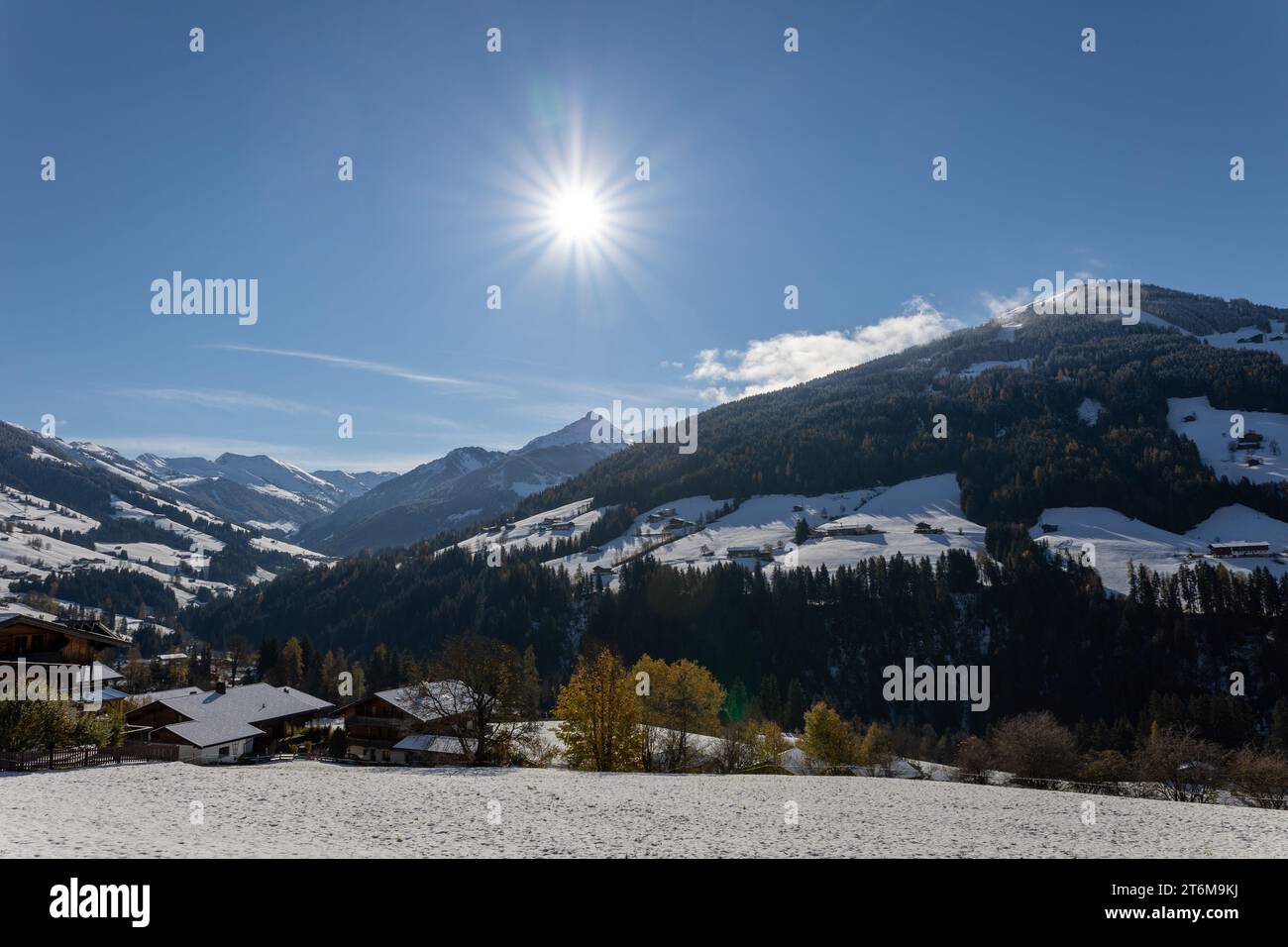 clear blue sky above alpbach village in austrian alps tyrol with snowy hills Stock Photo